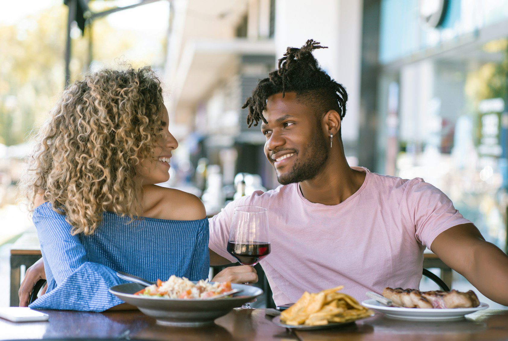 Couple enjoying a meal together at outdoor restaurant
